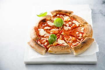 Traditional Pepperoni pizza with fresh basil