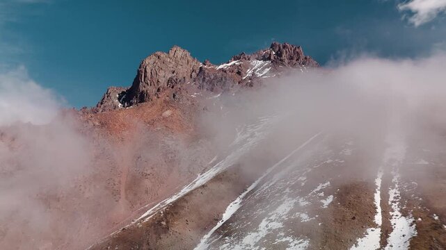 Aerial of snowy mountain range with snow