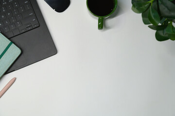 Flay lay, Top view office table desk with computer, coffee, pen, leaves with copy space background.