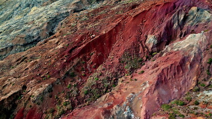 Rugged mountains slope red rocky surface aerial view. Beautiful boulders erosion