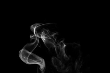 White smoke on black background. Figured smoke on a dark background. Abstract background, design element, for overlay on pictures.