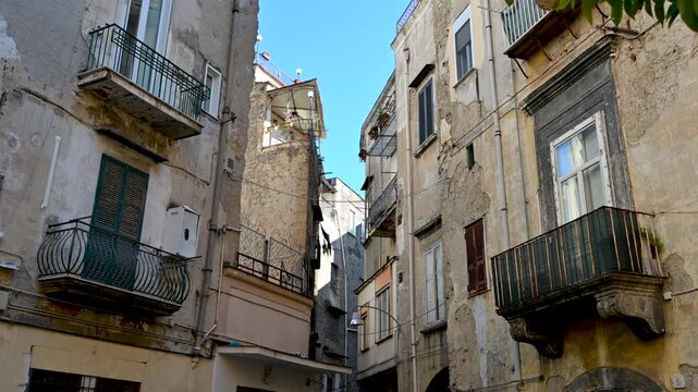 Naples, Italy, December 29, 2024. In a side street in the historic center, we find an example of the area's characteristic urban landscape. Houses with closely spaced facades and a modest exterior.
