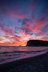 Montenegro, Europe: a fiery sunset on Buljarica beach, one of the largest beaches of the coast, close to Petrovac in direction of Bar (Budva municipality)
