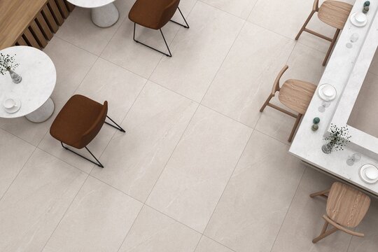 Cozy bistro setup with tiled flooring and ambient yellow lighting. Top view of cafe interior. 3D Rendering