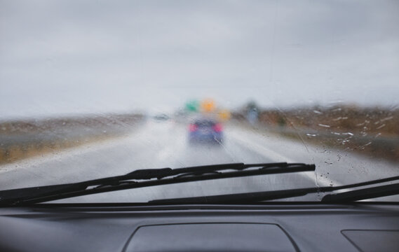 Car road driving in rain bad weather windshield rain drops 