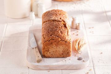 Tasty oat bread baked in a rustic bright kitchen.