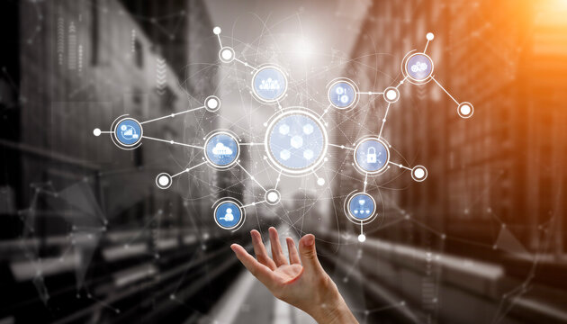 A hand reaches out towards a cluster of digital icons, symbolizing connectivity and technology in a modern urban setting, emphasizing the future of digital interaction. Tessel