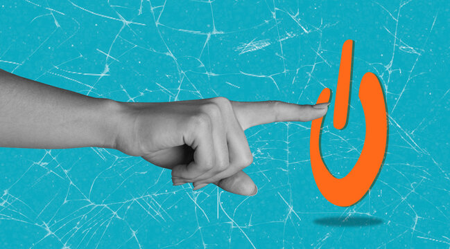 Hand pressing power button on a bright blue background with cracks, symbolizing activation and technology