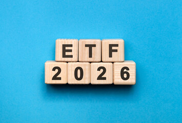 New year ETF 2026 concept. Wooden cubes on a blue background