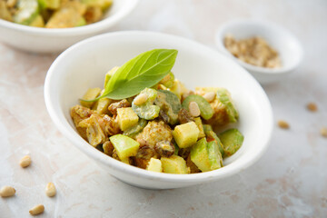 Chicken with celery, zucchini and pine nuts