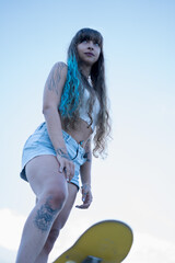 Young woman enjoying outdoor active lifestyle with skateboard