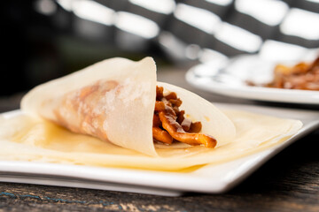 Hoisin chicken pancakes on a wooden background. Chinese cuisine. Asian food. Food concept