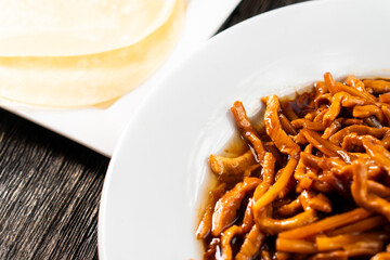 Hoisin chicken pancakes on a wooden background. Chinese cuisine. Asian food. Food concept