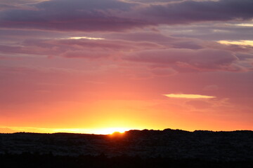 dramatic sunset after a storm with vivid colors and heavy clouds