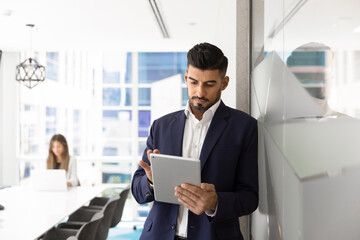 Fototapeta premium Focused busy Indian manager man using business application