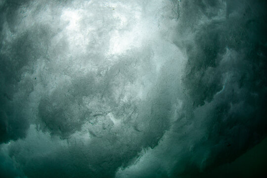 Bubble underneath breaking wave in the ocean.