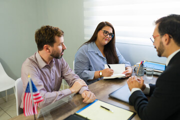 Latin couple meeting immigration lawyer for legal advice