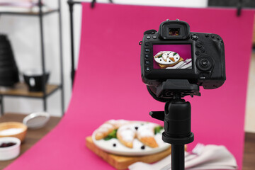Shooting tasty croissants with camera in studio, selective focus. Professional food photography