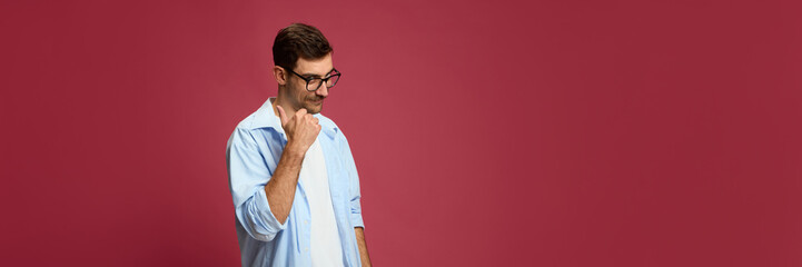 Thoughtful man touching chin with skeptical look and raised eyebrows. Concept of decision-making,...