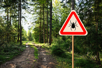 Warning sign marking habitat of ticks in forest