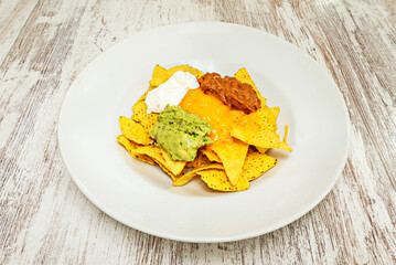nachos with braised beef, broth for dipping, and finely chopped fresh cilantro