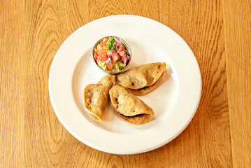 Squash blossom quesadillas with squash blossoms, ricotta cheese, and herbs on handmade tortillas