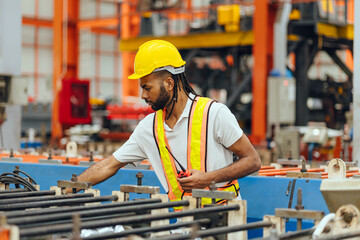 Professional African black worker working machine operator in heavy industry factory supervisor