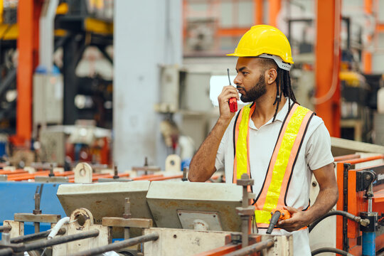 Professional African black worker working machine operator in heavy industry factory supervisor