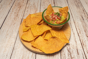 Chicken Tinga nachos with chipotle shredded beef, Monterey Jack cheese, and freshly chopped cilantro
