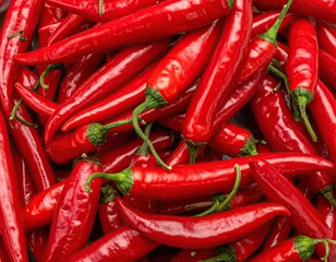 Pile of Vibrant Red Chili Peppers with Green Stems Close Up Still Life Arrangement