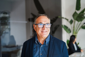 Caucasian business senior man smiling on camera inside corporate office - Entrepreneur and career concept - Focus on face