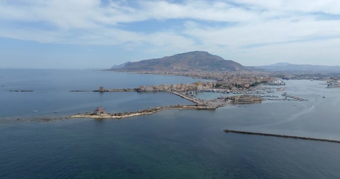 Aerial view of Trapani, Sicily, Italy. It is a Sicilian city with a port overlooking the Mediterranean Sea. Mount Erice dominates the town in the background.