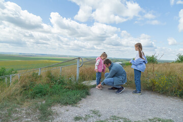 Fototapeta premium Father and daughter stand on scenic landscape