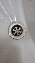 Close-up of an old metal bathroom drain