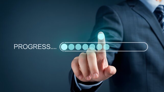 Businessman in a suit pointing to a virtual progress bar for business growth and success