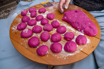 Woman hands making pastry. Colored bread dough making process.