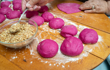 Woman hands making pastry. Colored bread dough making process.