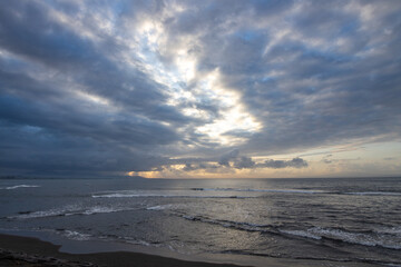 The sky is cloudy and the sun is shining through the clouds