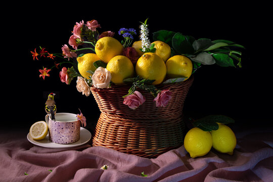 Still life with lemon, flowers and tiny a bired