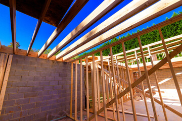 Workers are constructing new wooden frames at building site construction rafters structure beams framework