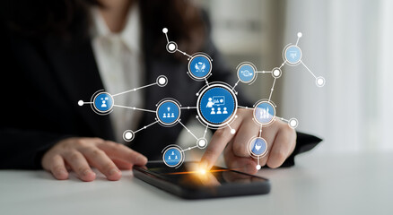 A business professional interacts with a smartphone, showcasing a digital overlay of networking...