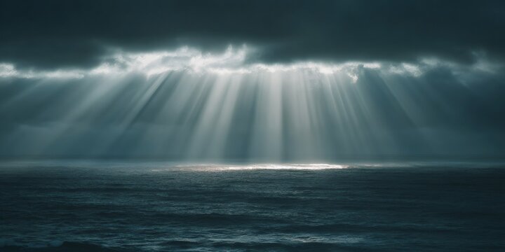 Golden sun rays breaking through dark storm clouds over deep ocean water, providing hope and a dramatic mood