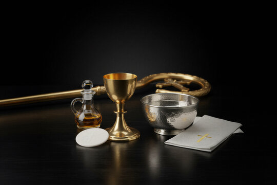 Catholic Eucharist elements chalice bread and wine on altar table

Holy Communion setup with golden chalice bread and sacramental wine

Christian Eucharistic symbols with chalice host and sacred oil