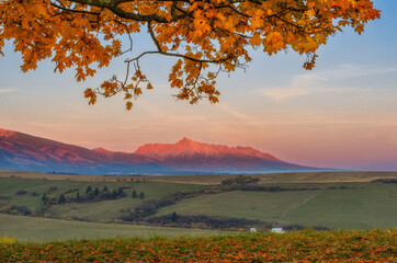 view of the West Tatras at sunset in autumn with fallen leaves