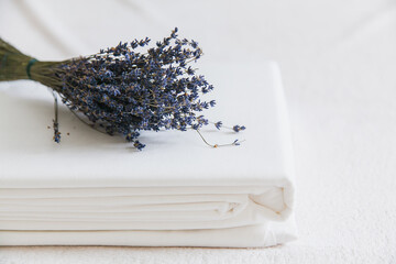 Fresh linen and dried lavender create a calming atmosphere in a simple setting