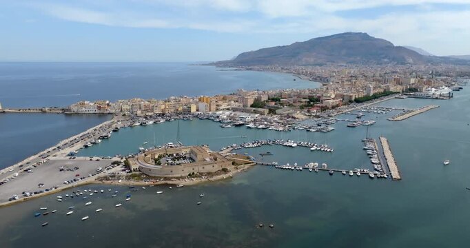 Aerial view of Trapani, Sicily, Italy. It is a Sicilian city with a port overlooking the Mediterranean Sea. Mount Erice dominates the town in the background.