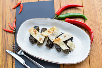 dolma in a white plate on a table with food decor