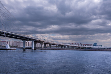 Fototapeta premium A long concrete bridge on pillars across the bay.