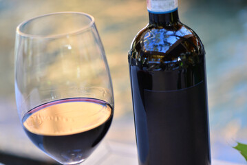 glass and bottle of red wine macro photo