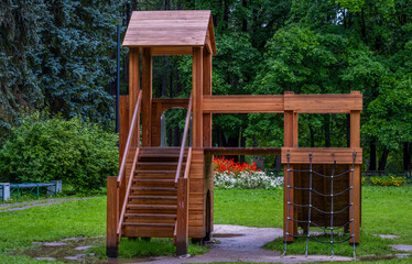 Children's slide made of wood on the playground.